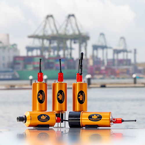 Multiple Subnero acoustic smart modems with aluminum hulls floating at a harbor, illustrating different hull material and depth-rating options for various deployments